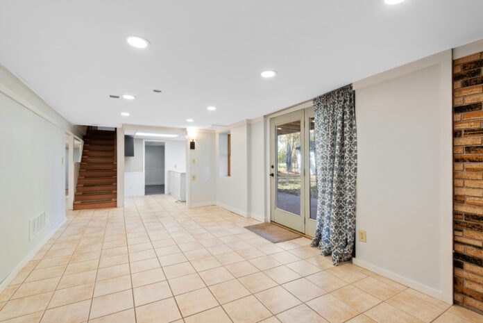 stylish basement featuring layered lighting, recessed lights, and modern fixtures to create a bright and inviting atmosphere.