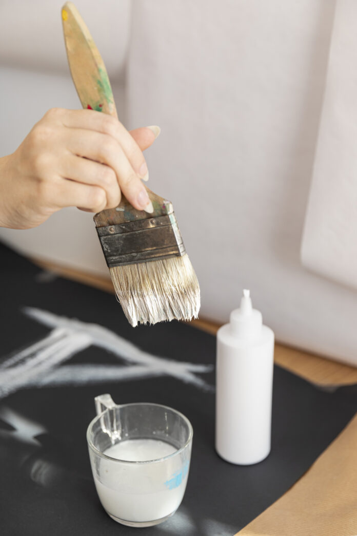 Close-up of a wood surface being coated with gel stain, showcasing its rich color and smooth finish.